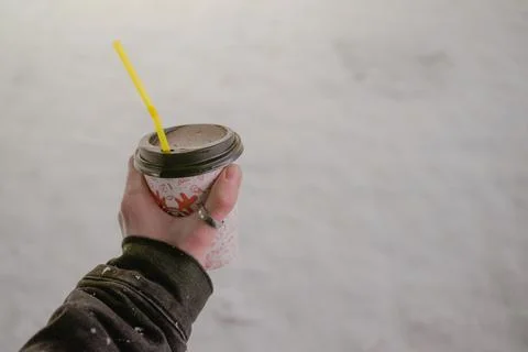 Paper cup in hand with you on the background of cold snow, winter period, hot Stock Photos