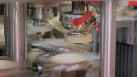 Paper cup making machine is manufacturing coffee cups at trade show: close up Stock Footage 337058117