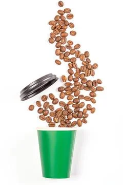 Paper cup with sprinkled coffee beans and lid Stock Photos