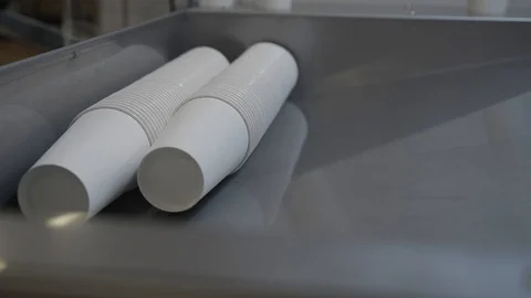 Paper cups are moved to packing area by pneumatic mail. Factory or plant indoor Stock Footage 93330229