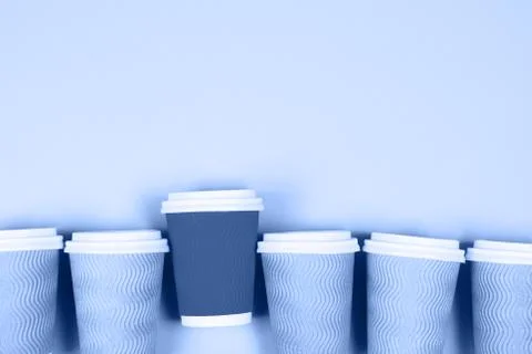 Paper cups on blue background Stock Photos