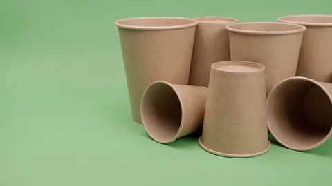 Paper cups on a green background. Stock Footage 127660489