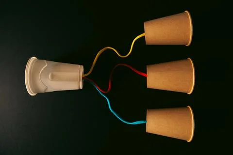 Paper cups with thread on table, close up. Stock-Fotos