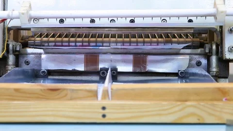 Paper is cut by an automatic machine. Close-up Stock Footage 129305957