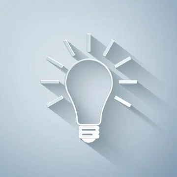 Paper cut Light bulb with rays shine icon isolated on grey background. Energy Stock Illustration