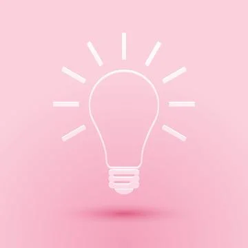 Paper cut Light bulb with rays shine icon isolated on pink background. Energy Stock Illustration