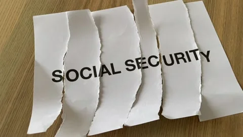 Paper cut into pieces in stop motion printed "social security" word Stock Footage 172289217