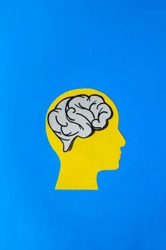 Paper Cutout of a Brain Inside a Head Silhouette Stock Photos