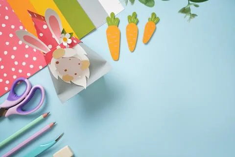 Paper cutting tools, scissors, eraser and finished gnome with egg. DIY projec Stock Photos