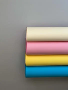 Paper in different colours rolls on a simple background Stock Photos