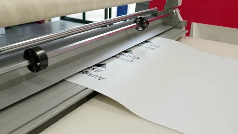 Paper with different imprints comes out of a machine Stock Footage 163079685