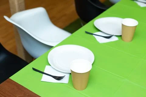 Paper disposable tableware on the table Stock Photos