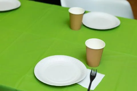 Paper disposable tableware on the table Stock Photos