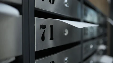 Paper document in mailbox of apartment building Stock Footage 311278207