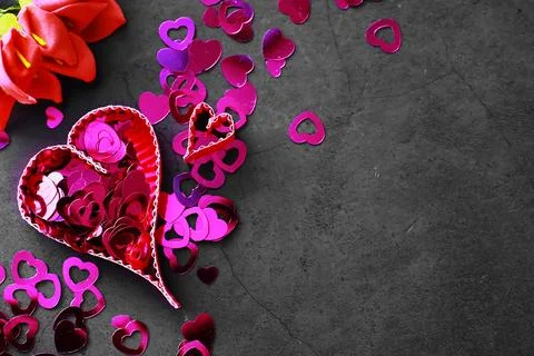 Paper elements in shape of heart on dark stone background. Love Valentine's.. Stock-Fotos