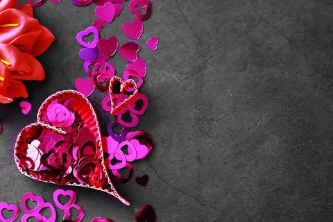 Paper elements in shape of heart on dark stone background. Love Valentine's.. Stock-Fotos