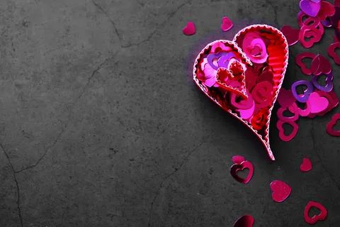 Paper elements in shape of heart on dark stone background. Love Valentine's.. Foto stock