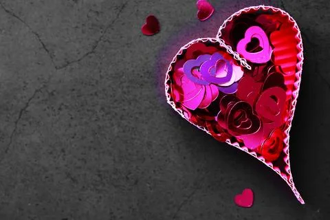 Paper elements in shape of heart on dark stone background. Love Valentine's.. Stock-Fotos