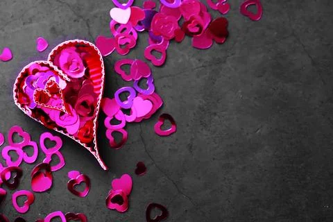 Paper elements in shape of heart on dark stone background. Love Valentine's.. 库存照片