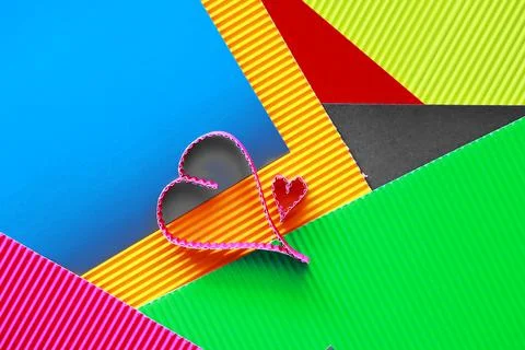 Paper elements in shape of heart on dark stone background. Love and Valentine Stock-Fotos