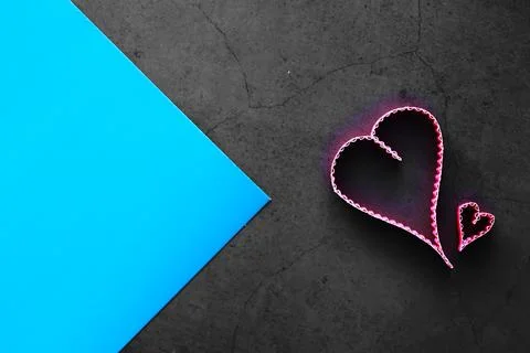 Paper elements in shape of heart on dark stone background. Love and Valentine Stock-Fotos