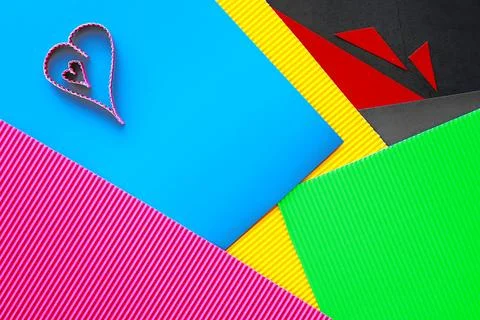 Paper elements in shape of heart on dark stone background. Love and Valentine Foto stock