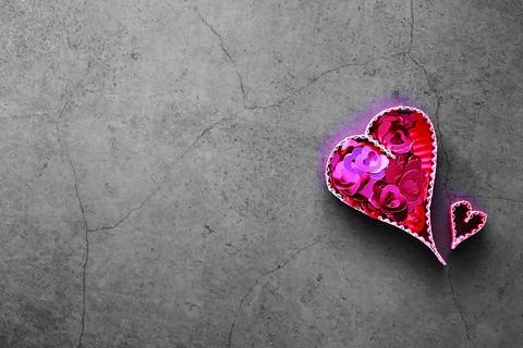 Paper elements in shape of heart on dark stone background. Love and Valentine Foto stock