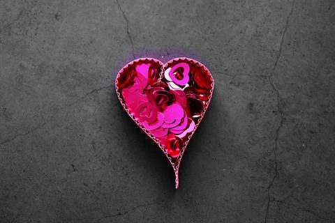 Paper elements in shape of heart on dark stone background. Love and Valentine Stock-Fotos