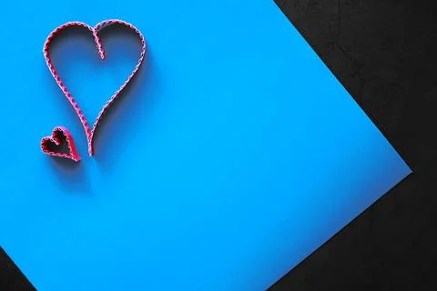 Paper elements in shape of heart on dark stone background. Love and Valentine Foto stock