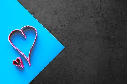 Paper elements in shape of heart on dark stone background. Love and Valentine 库存照片