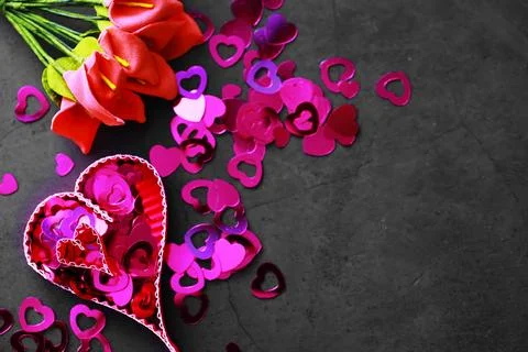 Paper elements in shape of heart on dark stone background. Love and Valentine 库存照片