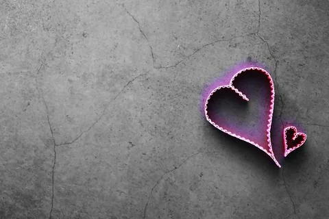 Paper elements in shape of heart on dark stone background. Love Valentine's.. Foto stock