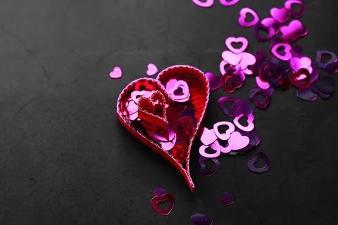 Paper elements in shape of heart on dark stone background. Love Valentine's.. 库存照片