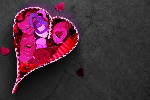 Paper elements in shape of heart on dark stone background. Love Valentine's.. Foto stock