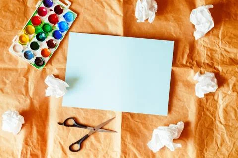 The paper is empty. crumpled paper. creative chaos. paints, scissors. Fotos Stock