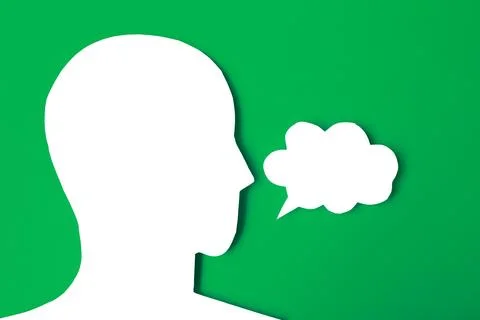 Paper face and speech bubble on colorbackground copy space for text, commun.. Stock Photos