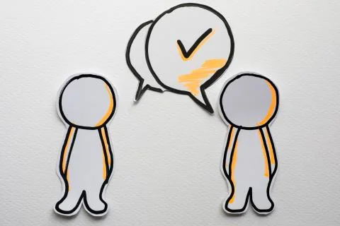 Paper figures with speech bubbles on the white Stock Photos