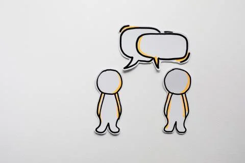 Paper figures with speech bubbles on the white Stock Photos