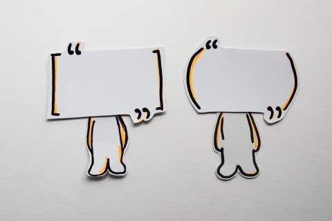 Paper figures with speech bubbles on the white Stock Photos
