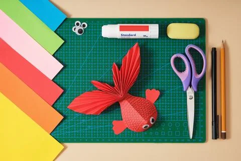 Paper fish craft using paper crafting tools. Scissors, colored paper, glue, p Stock Photos