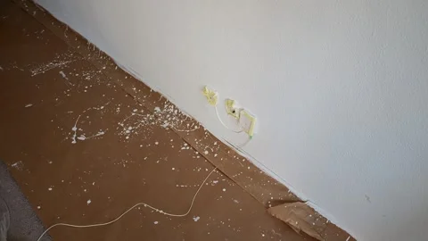 Paper floor protection covered in white paint drops during a home renovation Vídeos de archivo 341363426