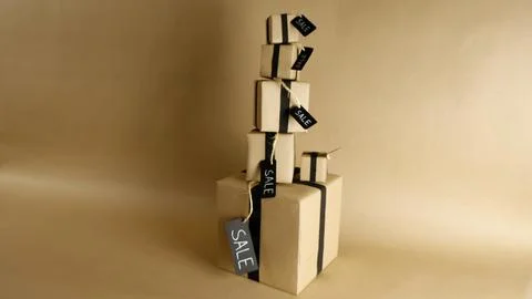 Paper gift boxes tower with black ribbons and sale tags Stock Photos