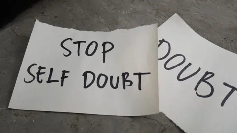 Paper with handwritten message STOP SELF DOUBT, self esteem concept. Stock Footage 255197218