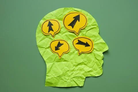 Paper head with arrows pointing in different directions. Stock Photos