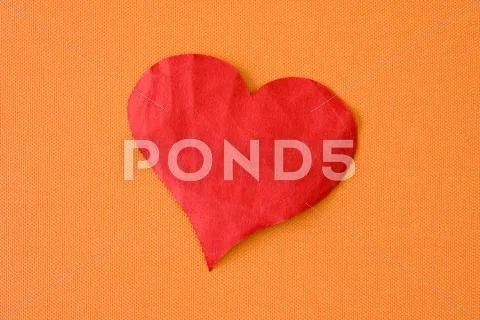 Paper heart on the orange background Stock Photos