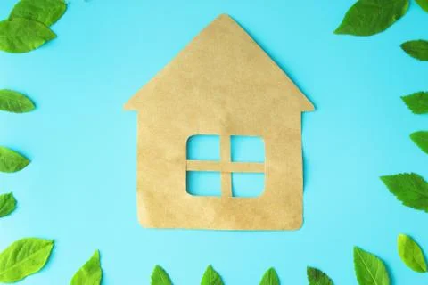 Paper house on blue background Stock Photos