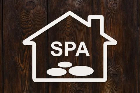 Paper house with SPA text inside. Abstract conceptual image Stock Photos