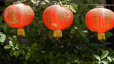 Paper lanterns on shabby building. Red paper lanterns hanging on ceiling of Stock Footage 107765798