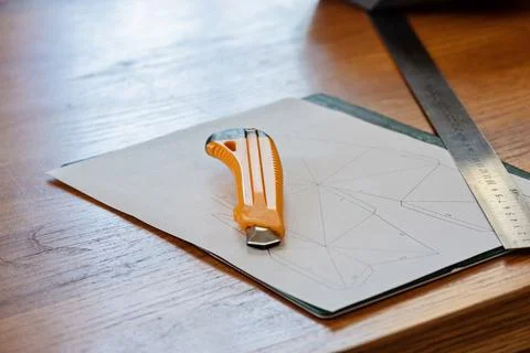 Paper, linear and knife on the table Stockfoto's