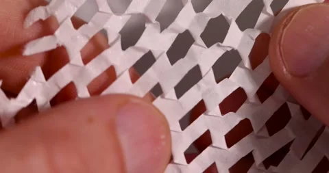Paper with a lot of cuts is used for packaging and decorative purposes, white Stock-Footage 324694207